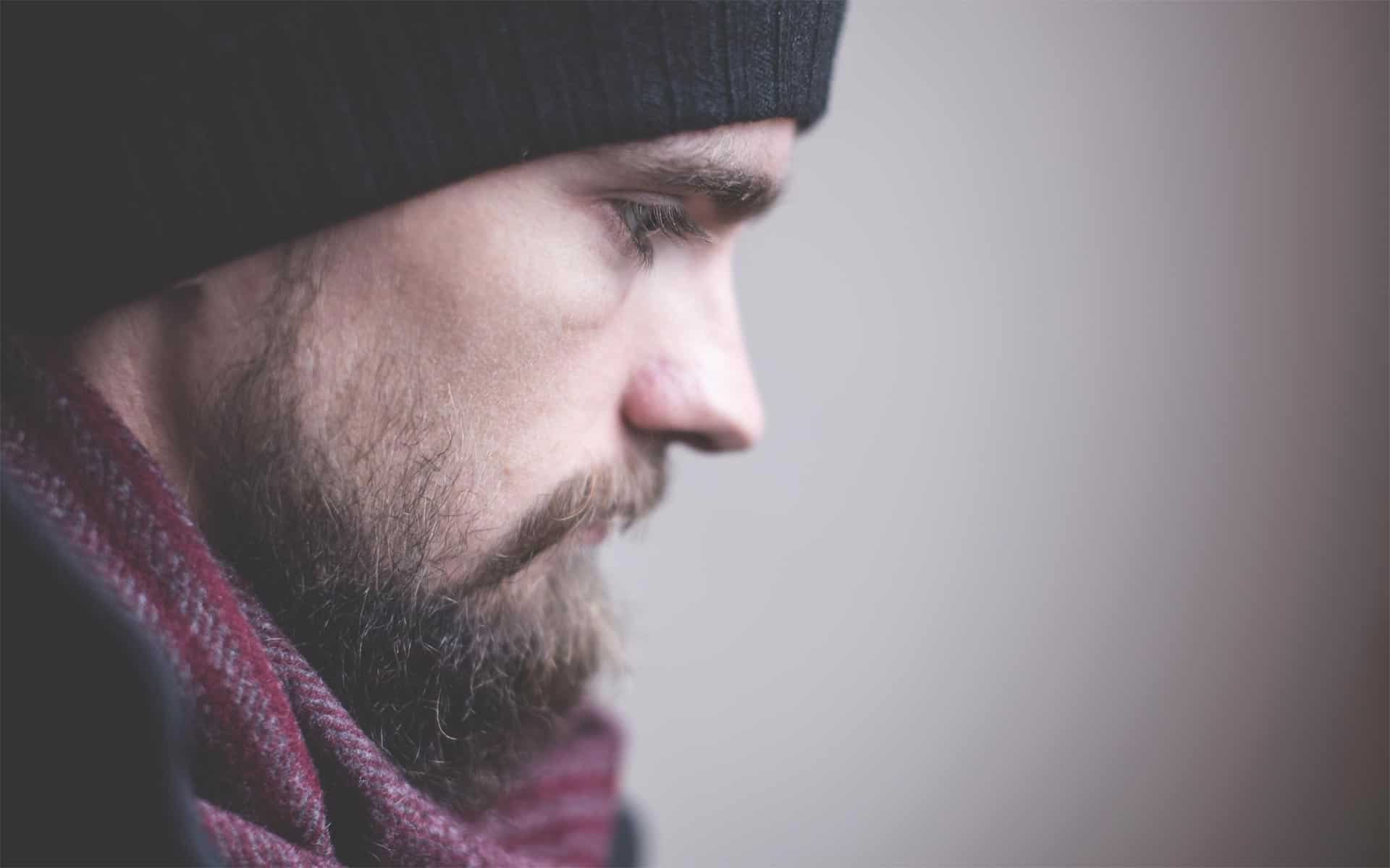 profile photo of a man's face dressed in warm clothing and looking concerned
